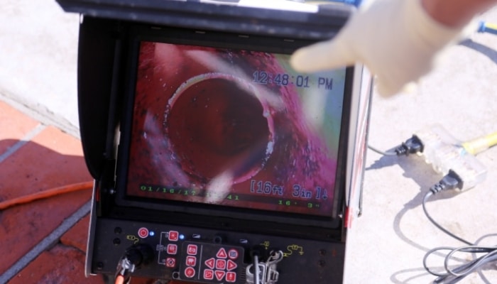 a camera image shows the inside of a plumbing pipe